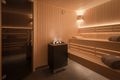 Classic Finnish Steam Sauna 4-Person interior, Nordic spruce wood, warm amber lighting, peaceful luxury wellness