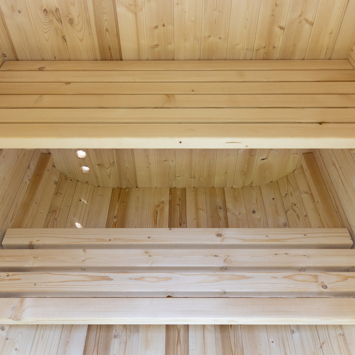 Wooden interior of a sauna with horizontal wooden slats.